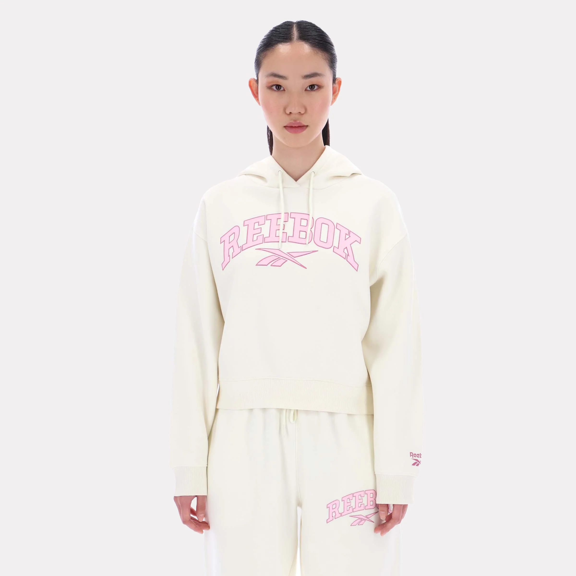 Reebok Apparel Women Varsity Logo Cropped Graphic Hoodie VINTAGE CHALK